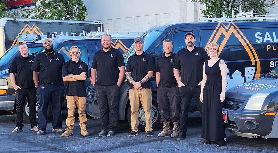 The Salt City Plumbing, Heating & Air team with their service vans